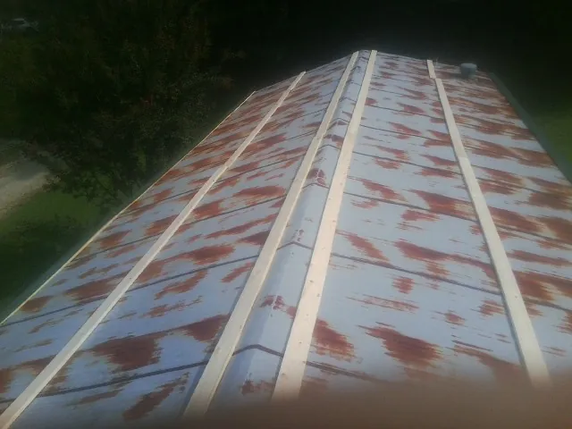 Rusted metal roof panels with new wood purlins before replacement — Storm Damage Roof Repair in Sulphur Springs by Roofing Brothers